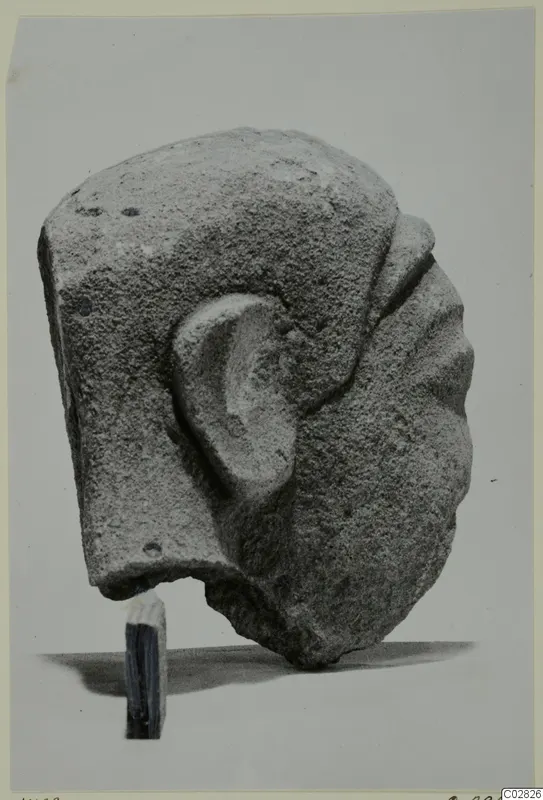 Limestone Cypro-Greek I head statuette from Kition, seen from the side with its ear modelled in relief.