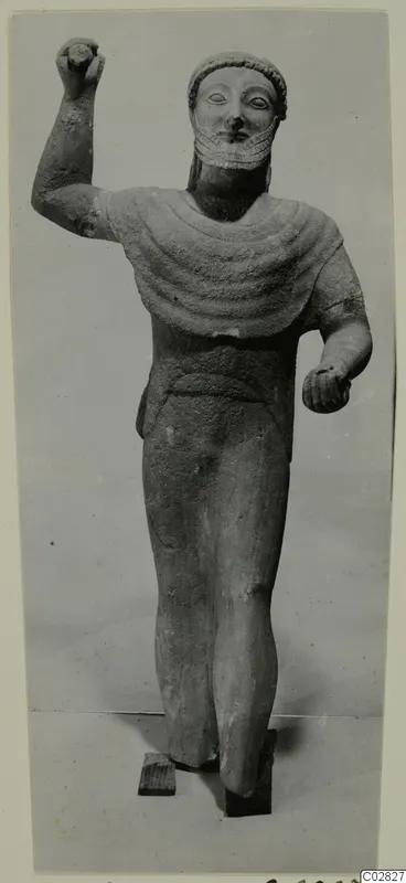 Limestone statue of a standing bearded figure from Kition, one arm raised