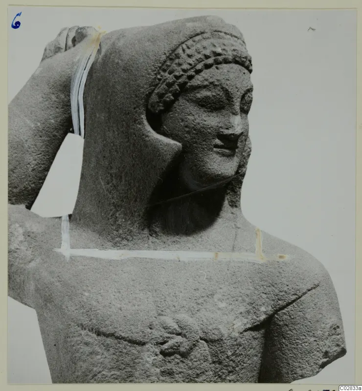 Limestone statue from Kition: head and upper body of a figure with curled hair and one arm raised