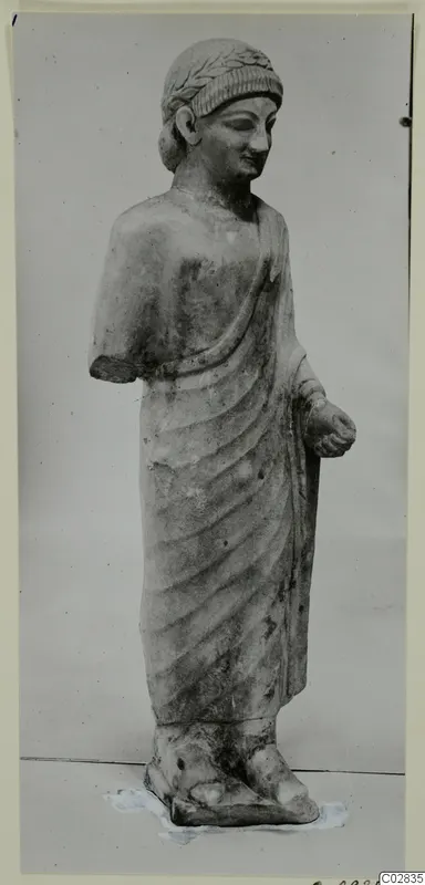 Limestone statue of a standing figure in a draped garment, from Kition