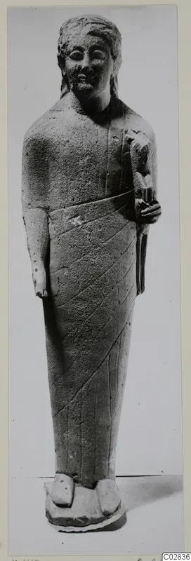 Limestone statue of a standing figure from Kition, full length, with incised drapery and a flat base