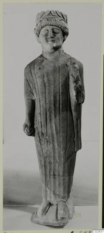 Limestone statue of a standing figure in a long robe and leafy headband, from Kition