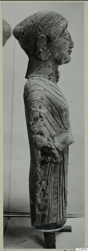 Limestone statue of a standing female figure in profile, facing right, from Kition