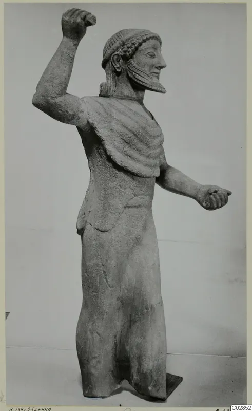 Limestone statue of a bearded male figure with one arm raised, from Kition