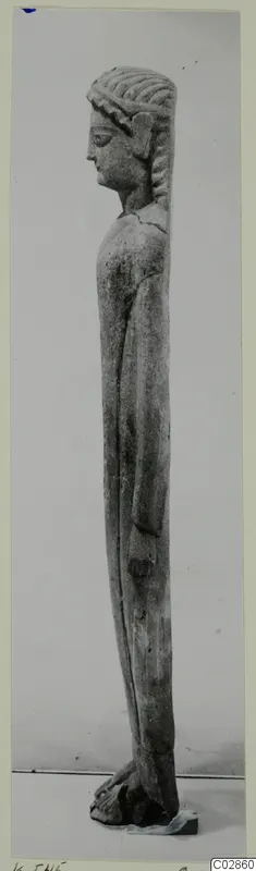 Limestone statue of a standing figure from Kition, seen in profile, facing left.