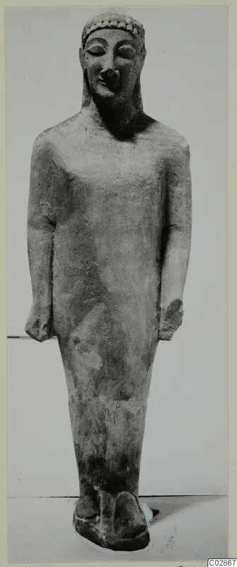 Limestone Cypro-Greek I statue of a standing male figure, seen from the front.