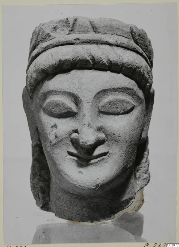 Limestone head from Kition with a broad hair band across the forehead, almond-shaped eyes and a slight smile