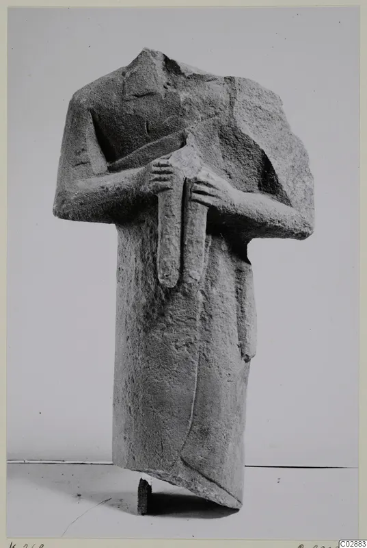 Headless limestone statue of a standing figure with arms crossed over the chest, from Kition