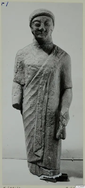 Limestone statue of a standing figure in a cap and cloak, from Kition