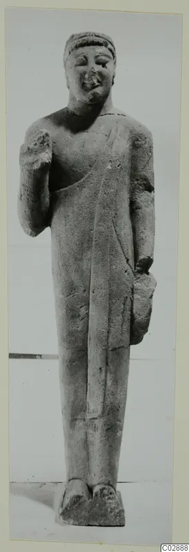 Standing limestone statue of a figure with a head band and one hand raised to the chest, from Kition