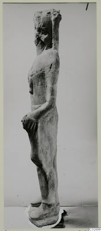 Limestone standing figure seen in side view, a find from Kition
