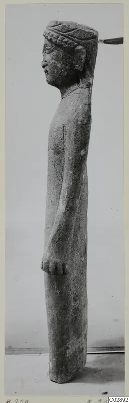 Limestone standing figure, shown in profile, with a banded headdress, from Kition