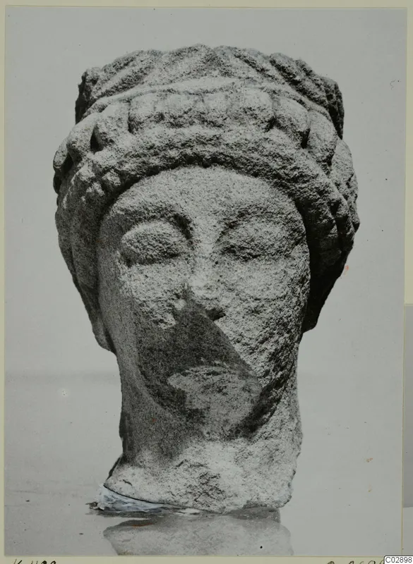 Limestone head from Kition with a tiered headdress and rounded curls