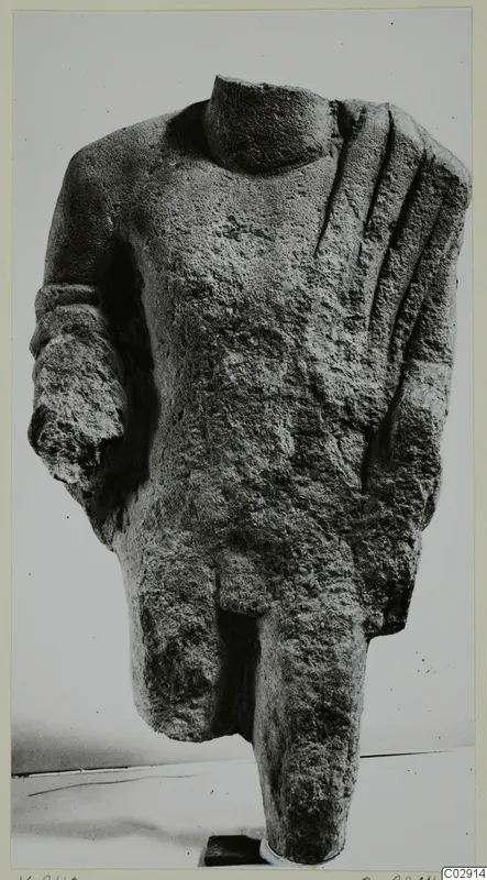 Headless limestone statue torso from Kition, with one arm partly preserved and grooved drapery folds