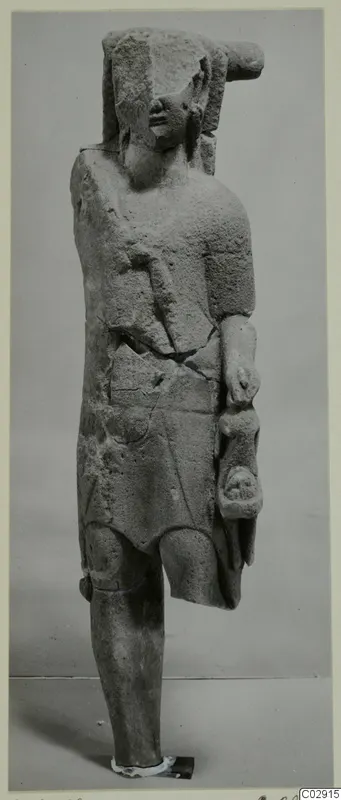 Limestone statue of a standing figure from Kition, with a broken headdress, cracked body and worn face.