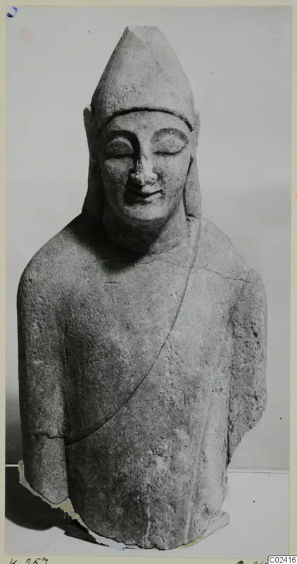Limestone sculpture of a figure with a tall pointed headdress and closed eyes, from Kition