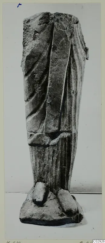 Limestone statue fragment from Kition: lower draped body and feet on a base