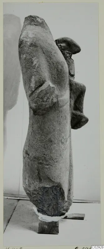 Limestone statue fragment K. 465 from Kition, seen from the side, with a bent arm and a projecting head or shoulder