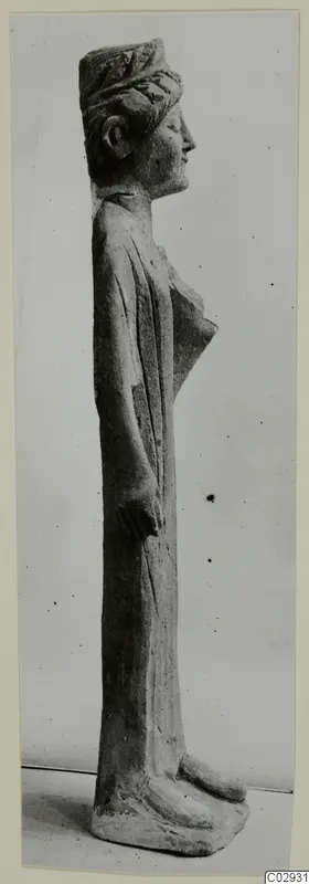 Standing limestone statue of a figure seen in profile, facing right, from Kition