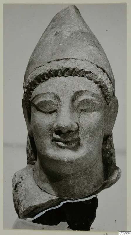 Limestone head of a figure with a tall pointed headdress, from Kition