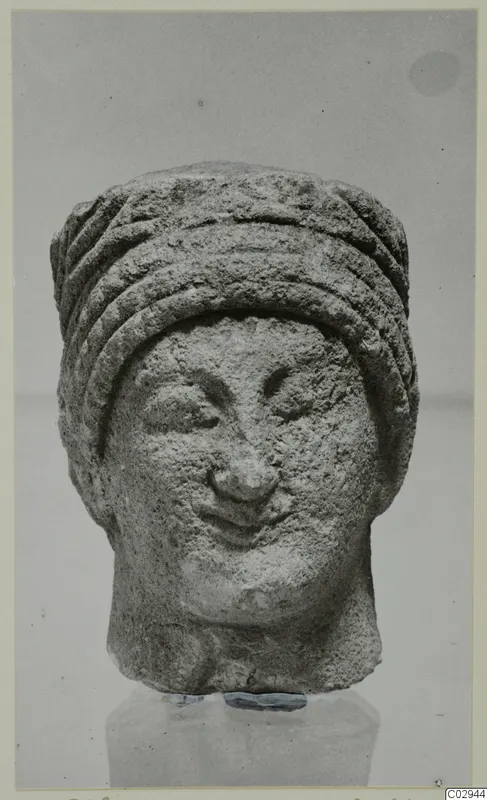 Limestone head from Kition with a ridged cylindrical headdress and a slight smile