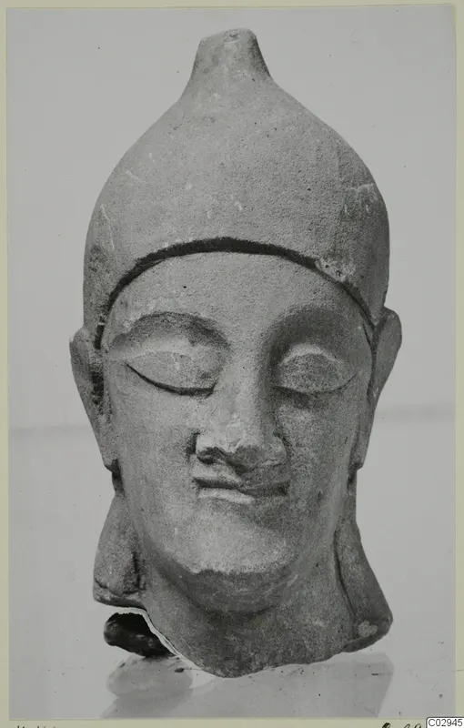 Neo-Cypriote limestone head from Kition with a tall pointed headdress and lowered eyes