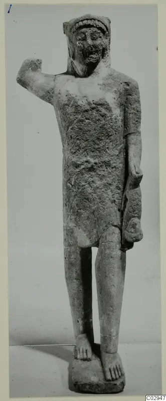 Limestone statuette of a standing figure with one arm raised, Kition