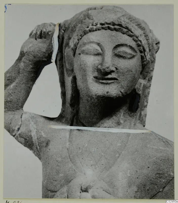 Limestone statuette of a female head and upper body, one arm raised to the head, from Kition.