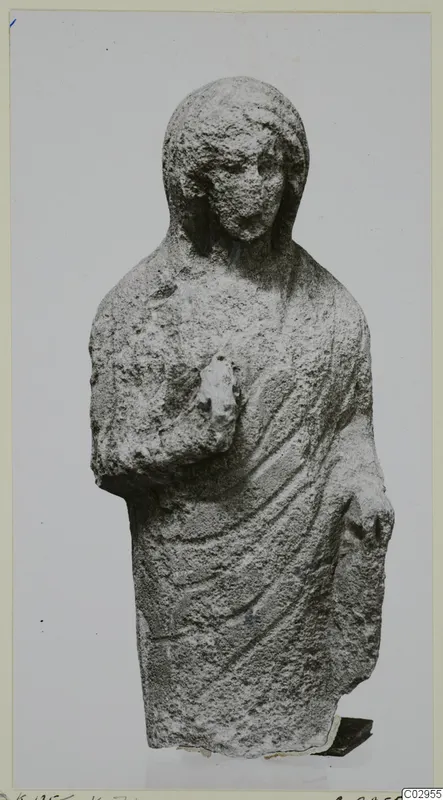 Limestone Cypro-Greek II statuette of a standing figure in a draped garment, from Kition