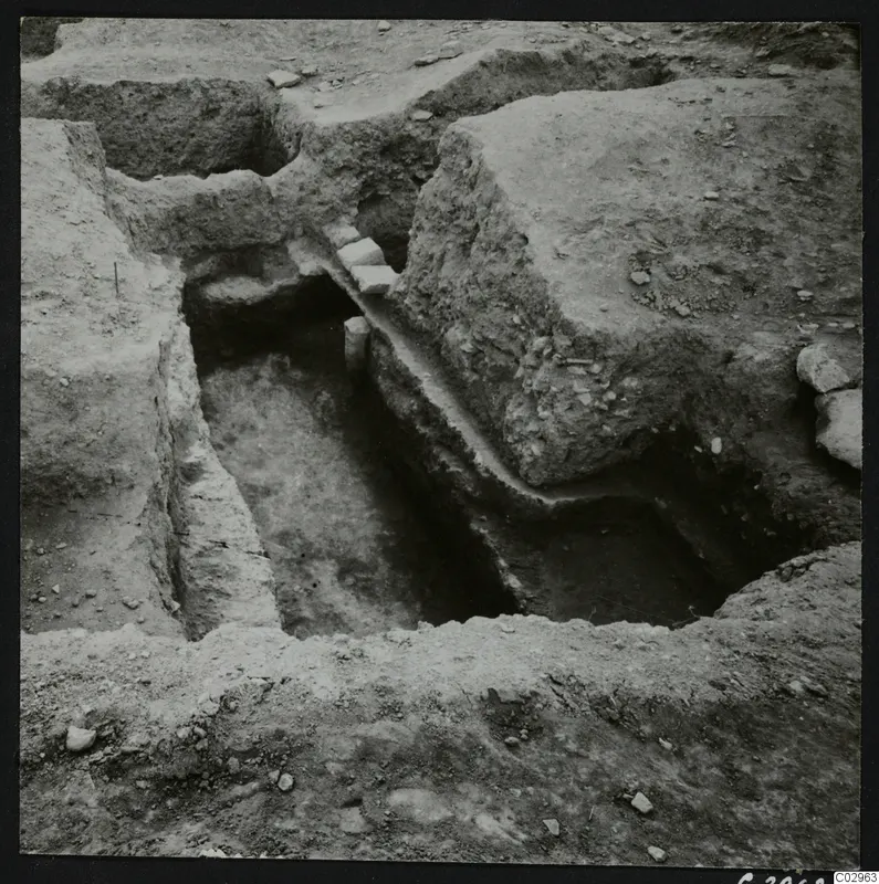Excavation trench at Amathus with small squared stones lying along the edge of a cut.