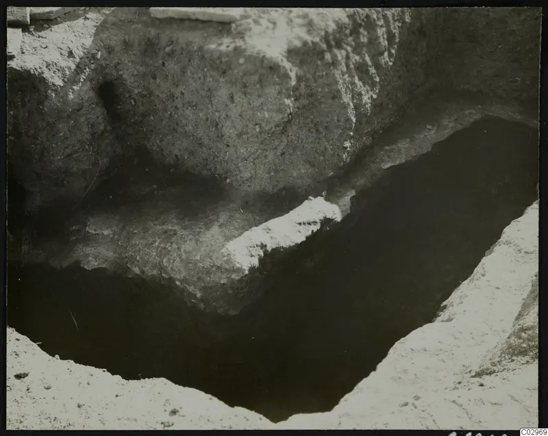 Excavation at Amathus showing a deep cut in the soil with stone blocks along its edge.