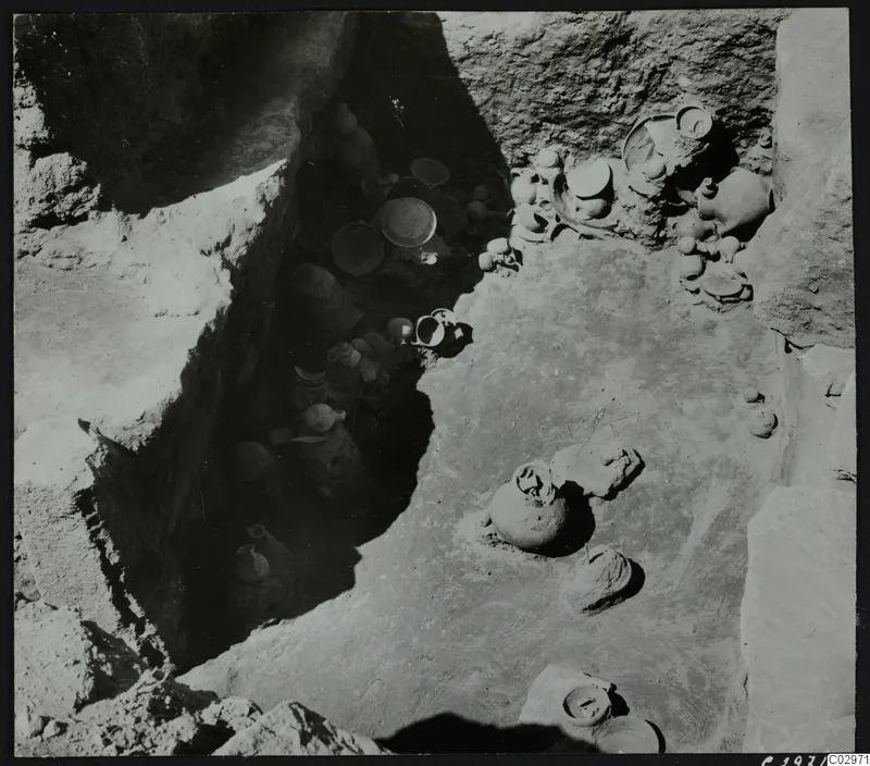 Excavation at Amathus with many pottery vessels lying in a trench and on a sloping floor