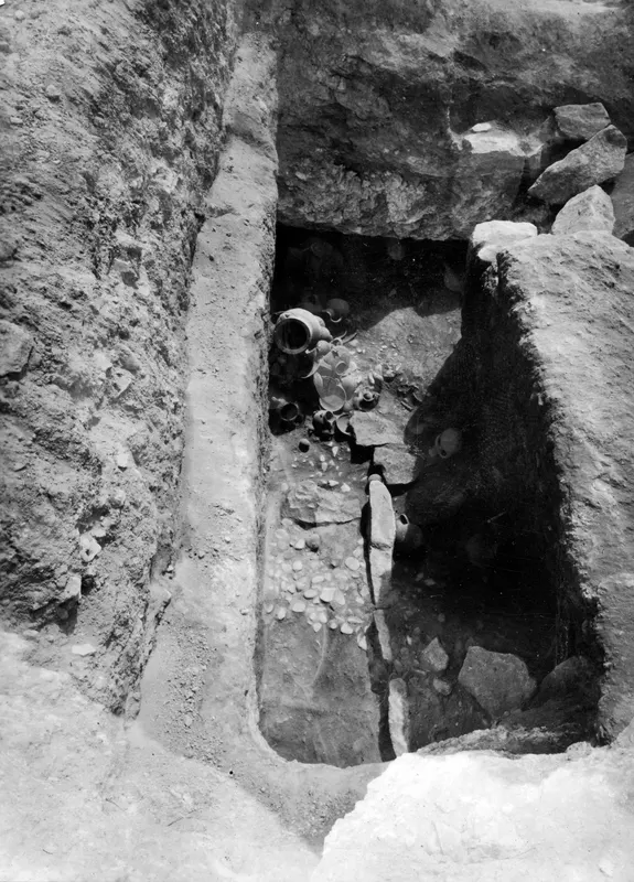 Tomb 14 at Amathus: pottery vessels lying on the floor of the find layer inside a cut passage and chamber.