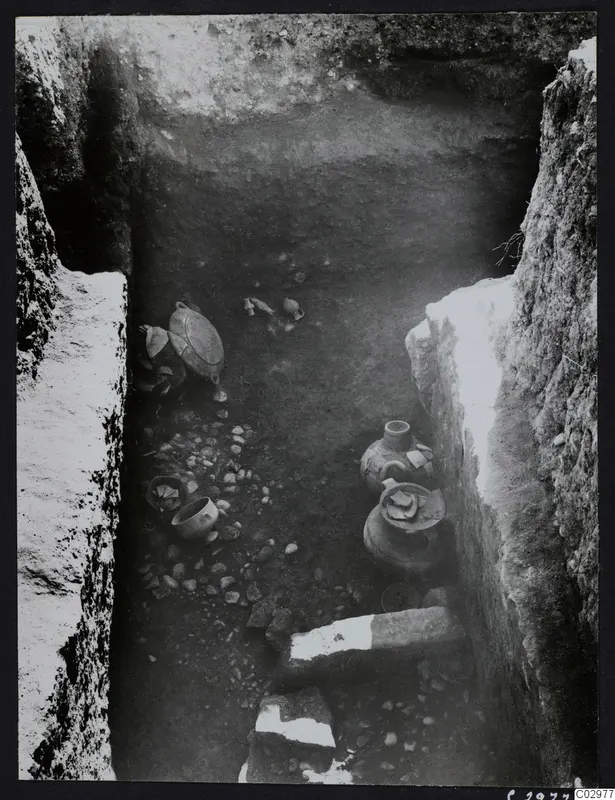 Excavation trench at Amathus with pottery vessels and stones on its floor