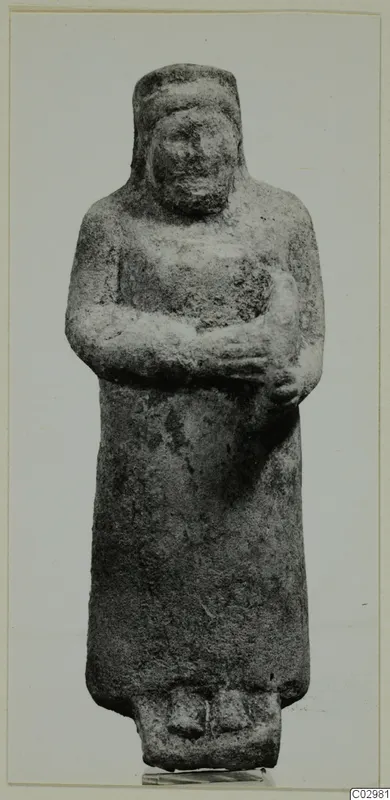 Limestone sculpture of a standing figure with arms folded across the chest, from Mersinaki