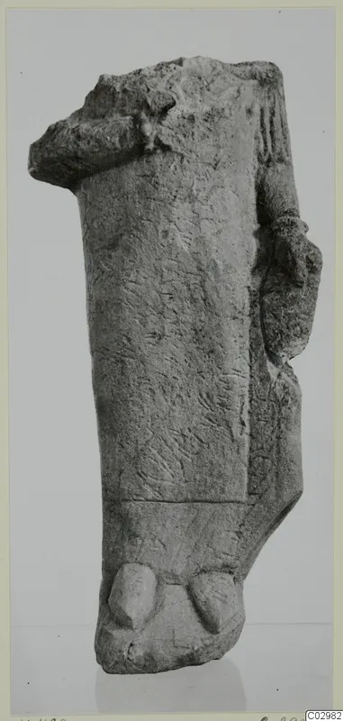 Fragment of a limestone statue from Vouni, broken at the top, with a projecting arm-like form at the right side