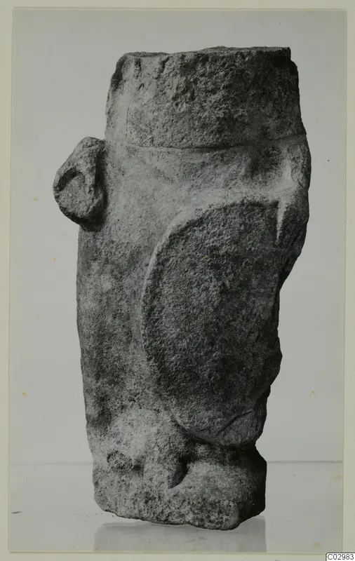 Limestone sculpture from Vouni with a cylindrical top, a large oval relief area and a small knob on the left side