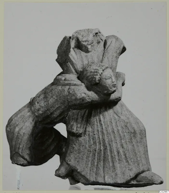 Limestone sculpture group of joined figures, one in a long pleated garment with a curly-haired head pressed against its shoulder