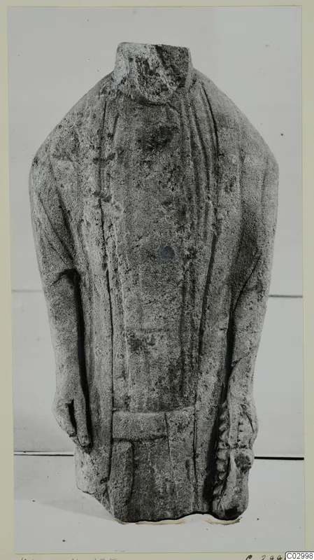 Headless limestone statuette of a standing figure in a long garment, from Kition