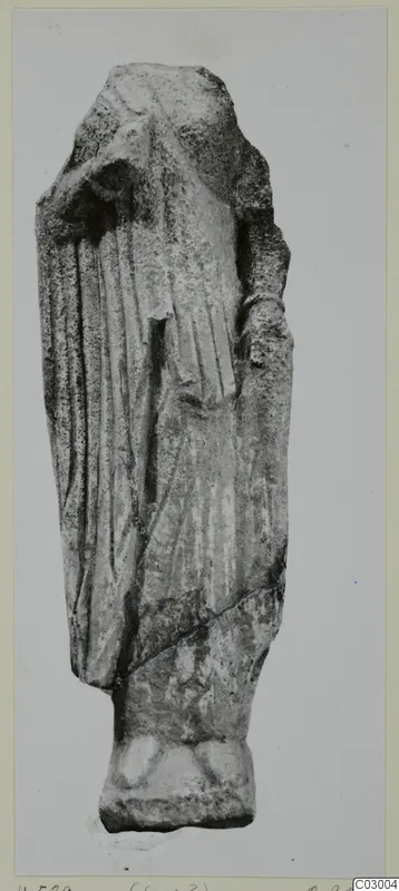 Limestone figure from Vouni, a standing draped figure with the head missing, shown on a rectangular base