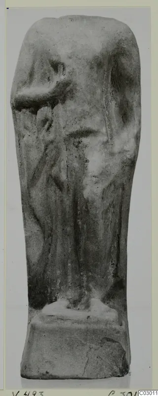 Figurine of a standing draped figure with one arm bent, on a rectangular base, upper part broken