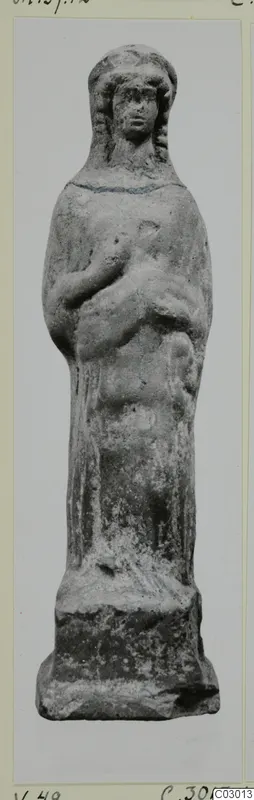 Terracotta figurine of a standing figure with long hair and hands raised to the chest, on a square base