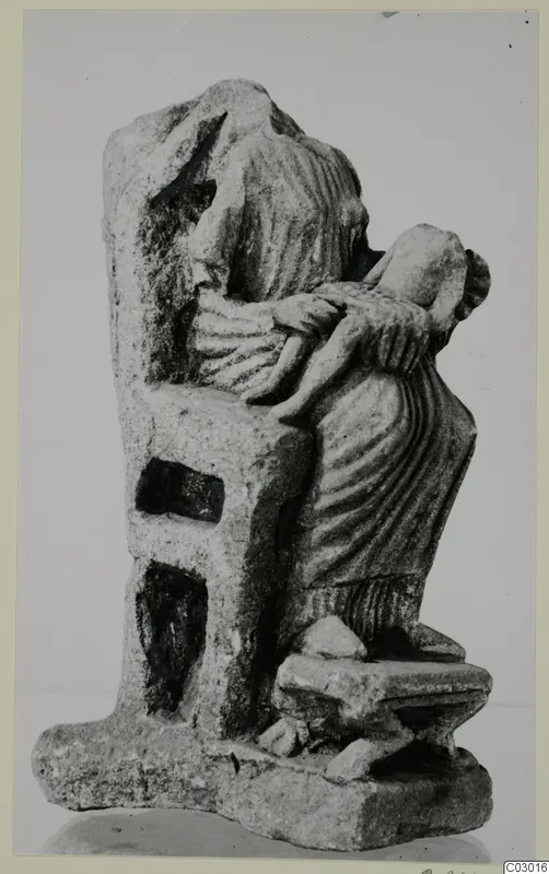 Limestone sculpture group of a draped female figure holding a small child, from Vouni; the larger figure's head is broken off