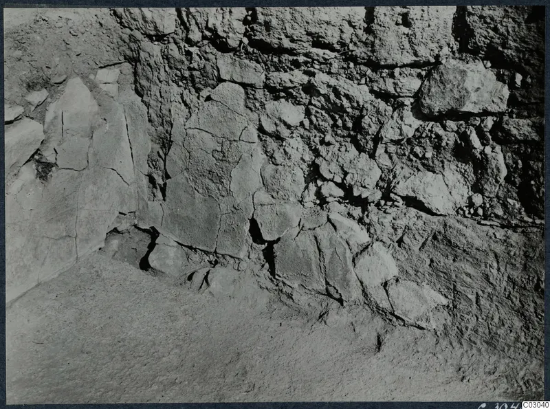 Excavated stone wall with a floor of packed earth at the palace at Vouni