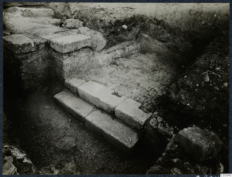 Stone steps and stone walls exposed in an excavation trench at Vouni