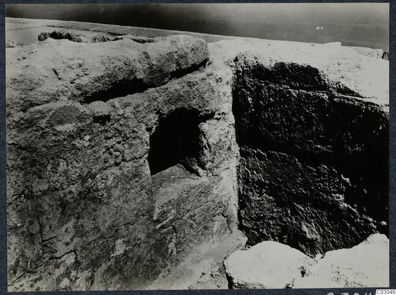 Rough stone masonry with a square recess at the palace at Vouni, with fallen stones in the foreground