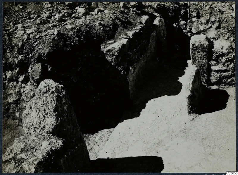 Large stone blocks exposed in a narrow excavated cutting at Vouni Palace