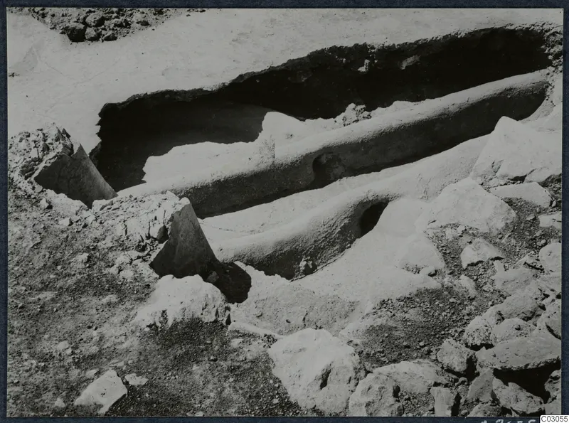 Excavation at Vouni palace with a long cut channel in pale earth and loose stones around it