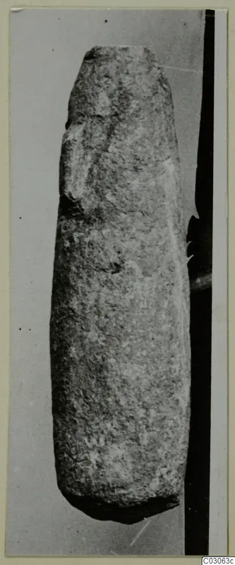 Tall, tapering stone vessel from Cyprus, standing upright against a grey backdrop.