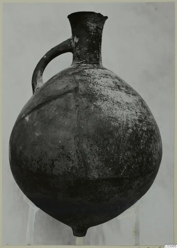 Pottery Black Slip Ware jug from Ayios Iakovos with a single loop handle and a flared neck